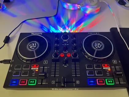 Close-up of a DJ controller with colorful pads